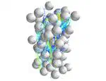Competing flow and collision effects in a monodispersed liquid--solid fluidized bed at a moderate Archimedes number